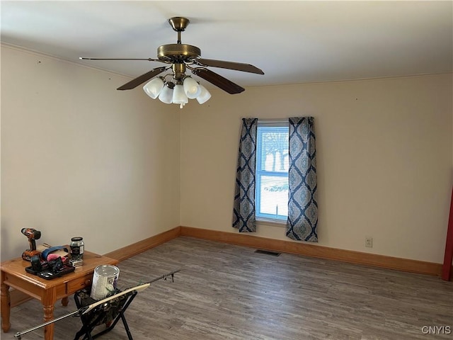 empty room featuring hardwood / wood-style flooring, ceiling fan, and ornamental molding