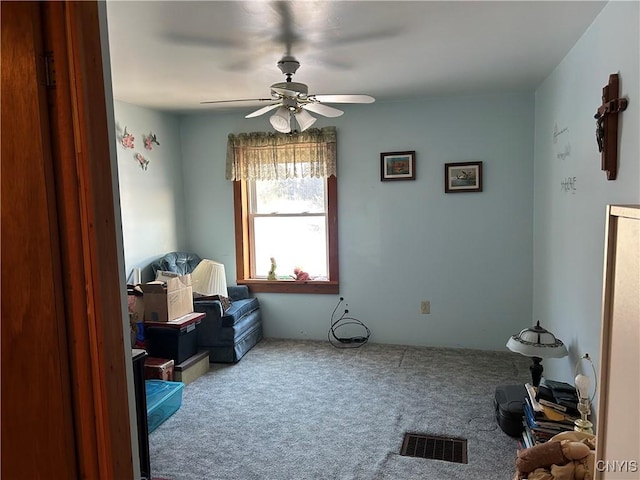 misc room with ceiling fan and carpet