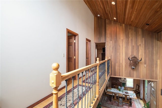 734 Post Rd, Franklin, NY 13775 - hallway featuring wooden walls, wood-type flooring, wood ceiling, and a high ceiling