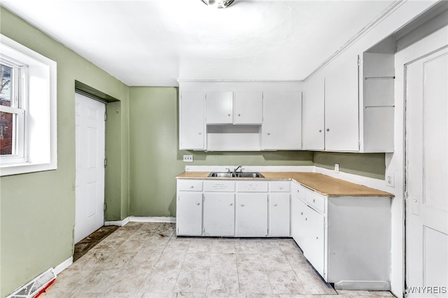 kitchen with white cabinetry and sink