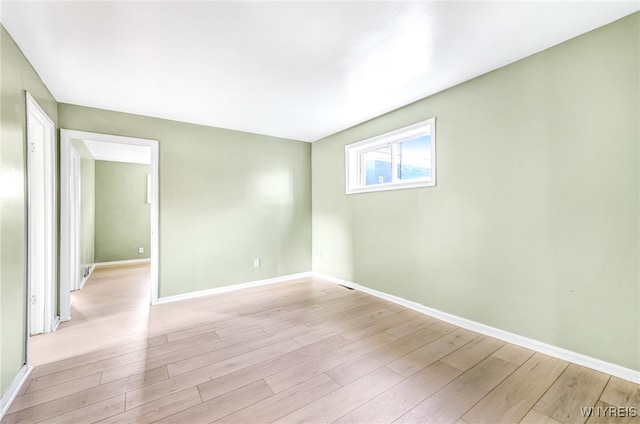 spare room with light wood-type flooring