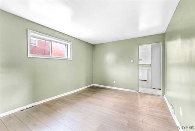 spare room with light hardwood / wood-style flooring