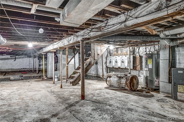 basement featuring heating unit and electric water heater