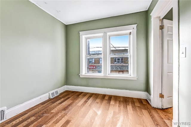 spare room with hardwood / wood-style flooring