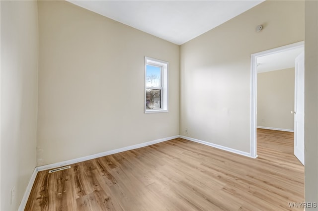 spare room featuring light wood-type flooring