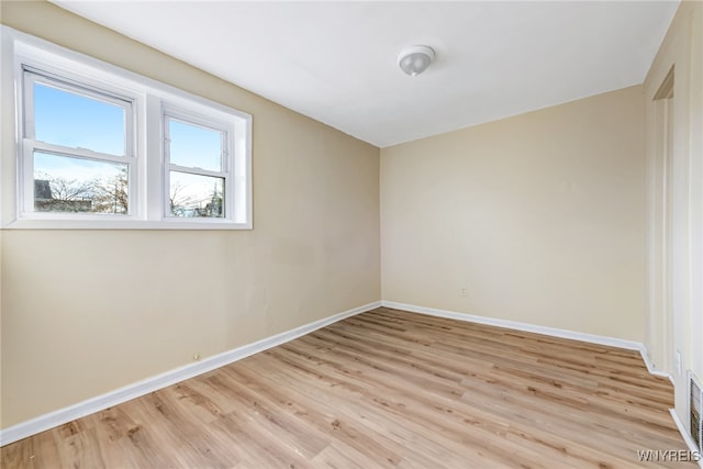 empty room with light hardwood / wood-style flooring