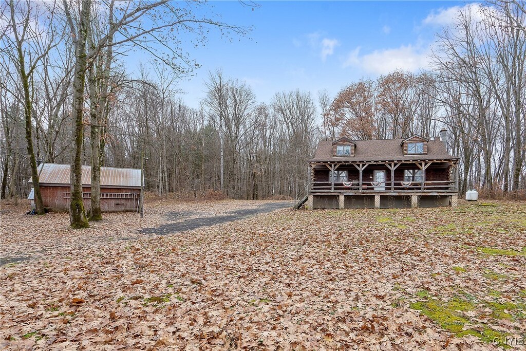 exterior space with an outbuilding and a porch