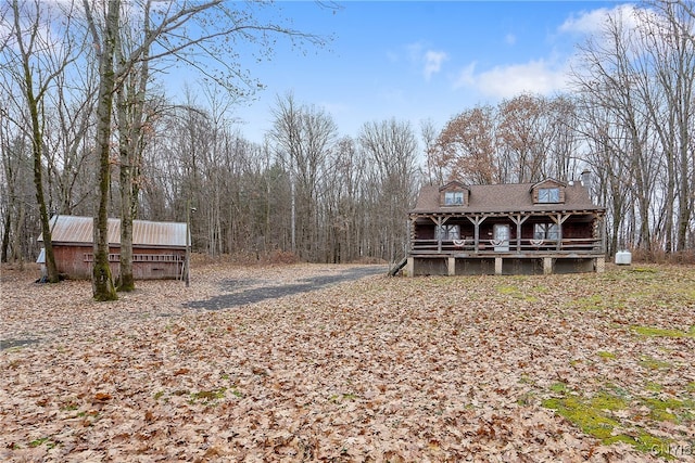 exterior space with an outbuilding and a porch