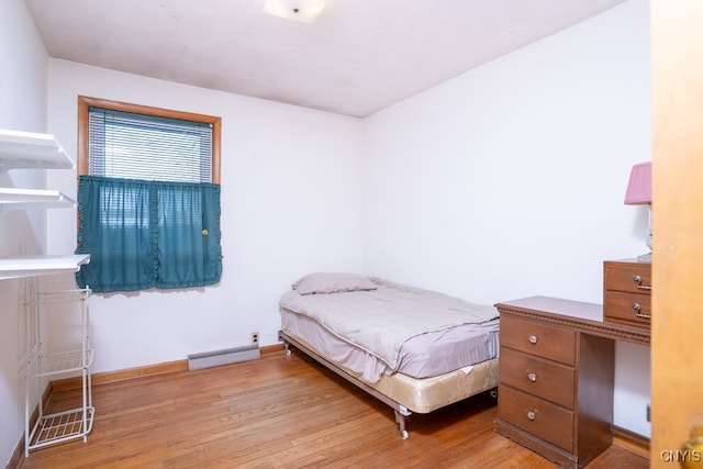 bedroom featuring wood-type flooring and baseboard heating