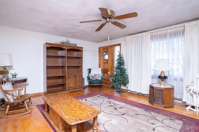 living room featuring ceiling fan and hardwood / wood-style flooring