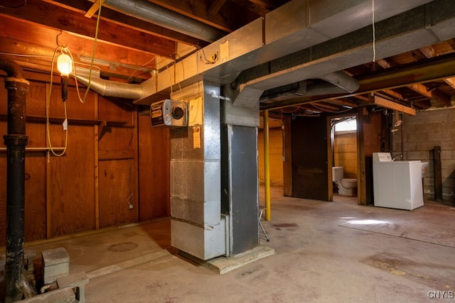 basement featuring washer / clothes dryer and heating unit