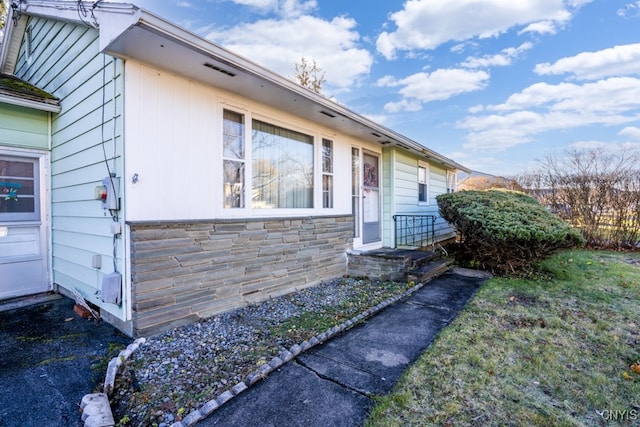 view of side of property with a lawn