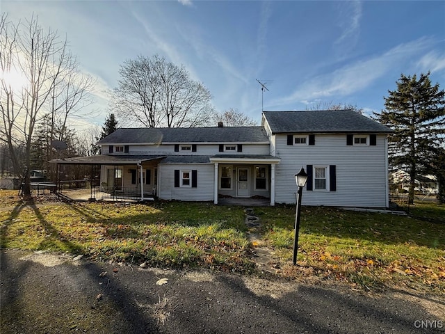 view of front of house with a front yard and a porch