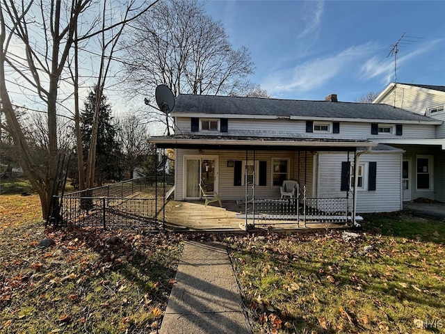 view of front facade with a wooden deck