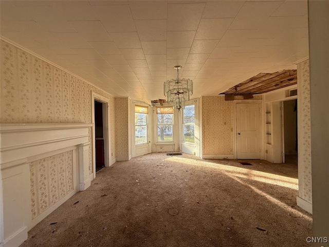 miscellaneous room featuring a chandelier and carpet floors