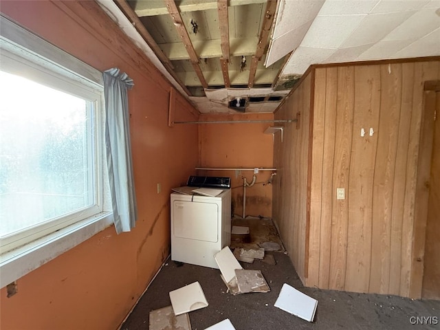 washroom with washer / clothes dryer and wood walls