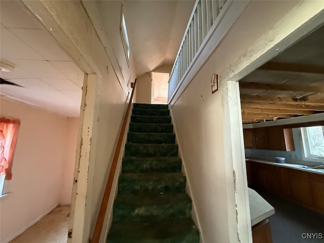 stairway featuring vaulted ceiling