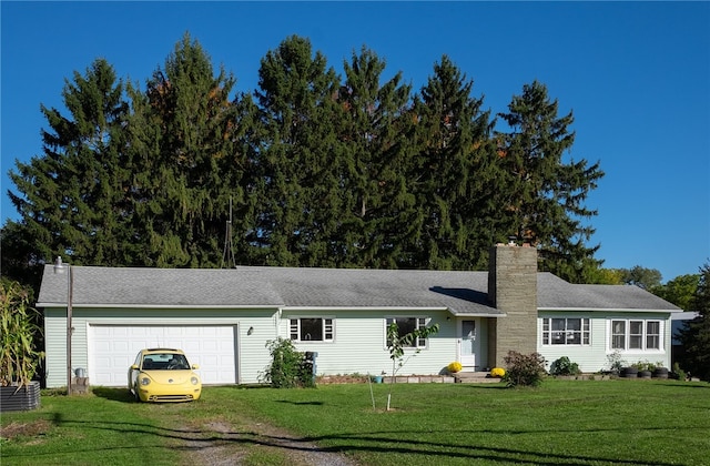 ranch-style house featuring a garage and a front lawn