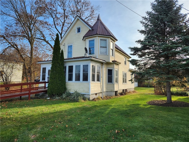 back of house with a lawn