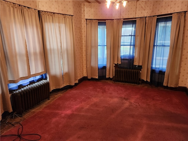 living area with dark carpet and radiator