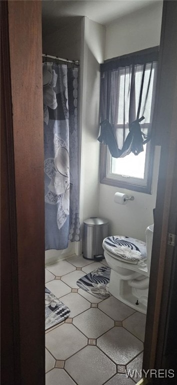 bathroom featuring tile patterned flooring and toilet