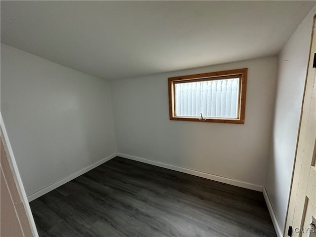 empty room with dark hardwood / wood-style floors