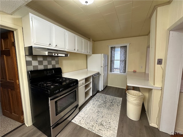 kitchen with white cabinets, decorative backsplash, dark hardwood / wood-style flooring, and stainless steel appliances