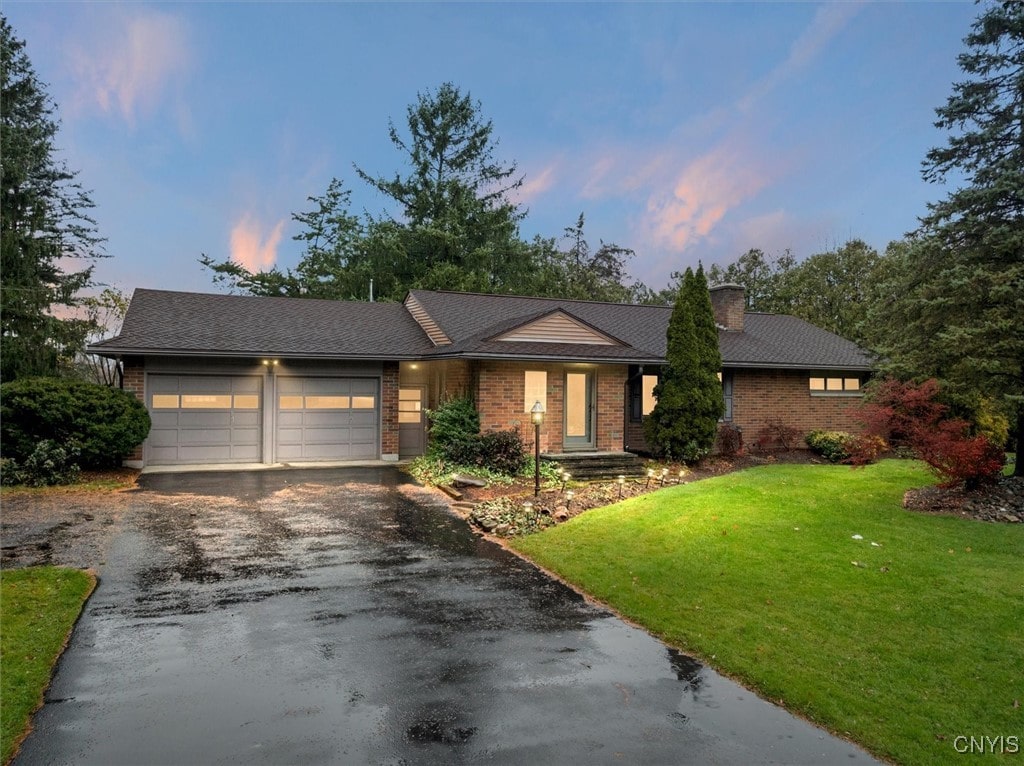 view of front of house with a lawn and a garage