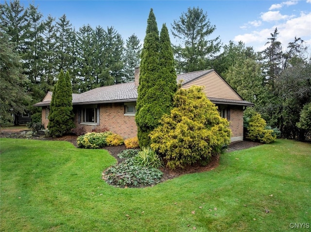 view of home's exterior with a lawn