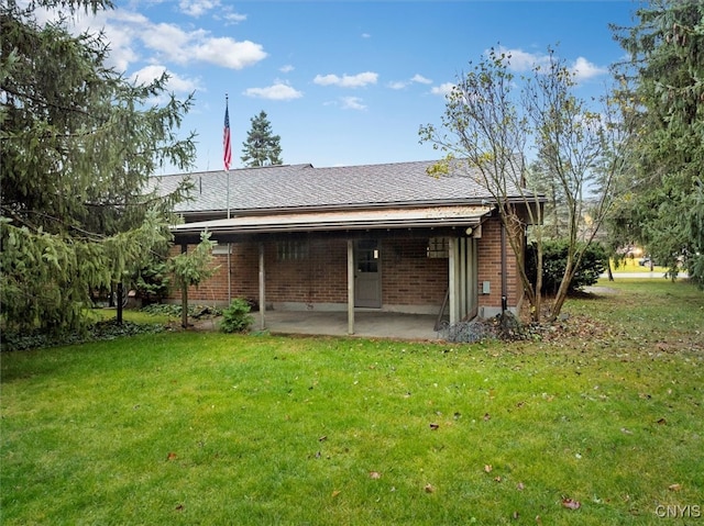 back of property featuring a yard and a patio