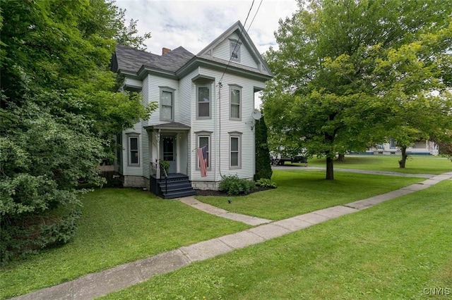 victorian-style house featuring a front yard