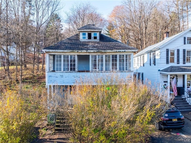 view of front of home featuring a sunroom