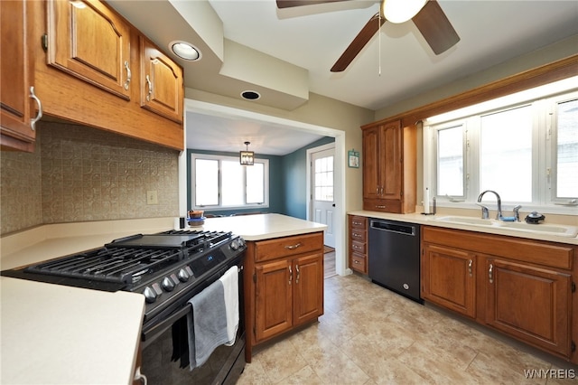 kitchen featuring black appliances, backsplash, a healthy amount of sunlight, and sink