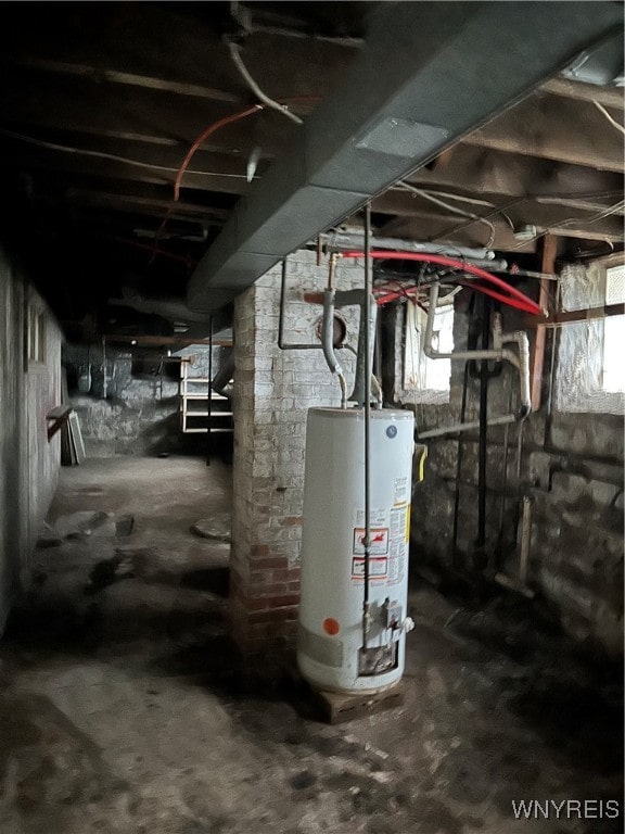 basement with gas water heater and a wealth of natural light