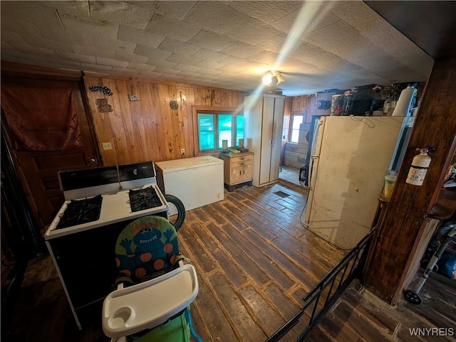 kitchen featuring wooden walls and dark hardwood / wood-style floors