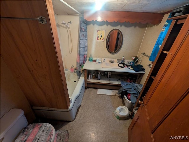 bathroom featuring sink and shower / bath combo with shower curtain