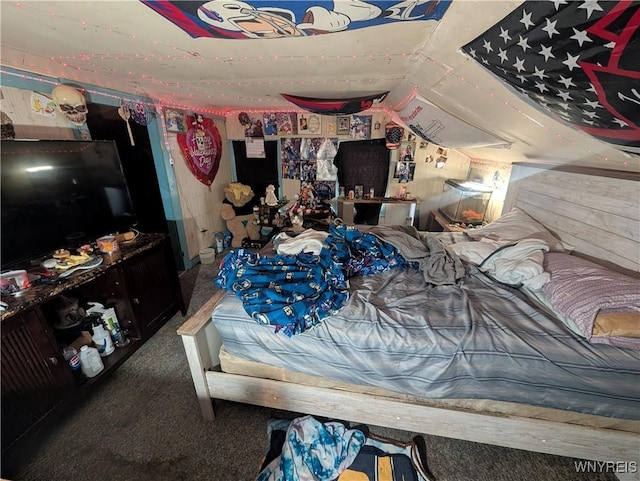 carpeted bedroom with lofted ceiling