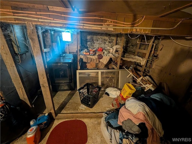 basement with washer / clothes dryer and a wood stove