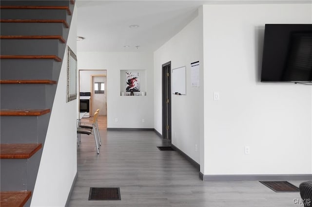 hall with hardwood / wood-style floors