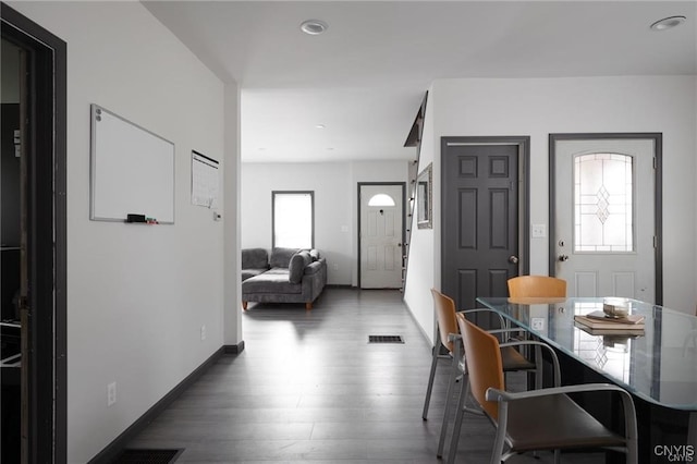 dining space with dark wood-type flooring