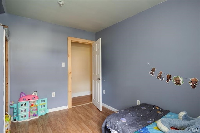 bedroom with hardwood / wood-style floors