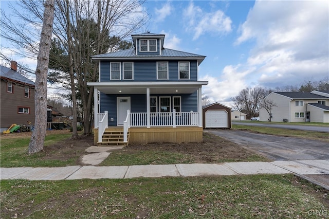 view of front of house featuring covered porch, an outdoor structure, and a garage