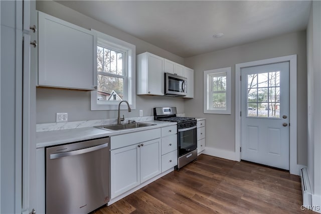 kitchen featuring a healthy amount of sunlight, white cabinetry, sink, and appliances with stainless steel finishes