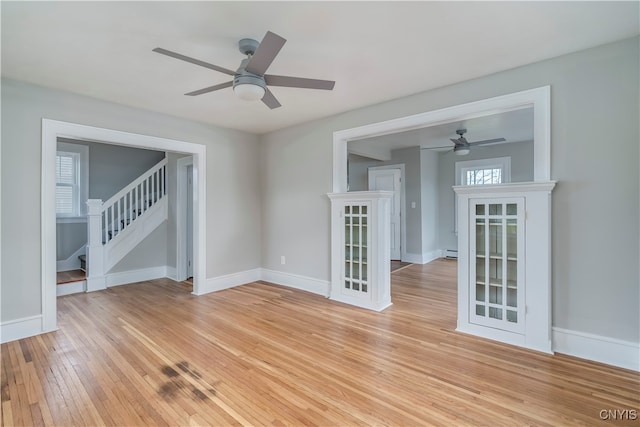 unfurnished room featuring light hardwood / wood-style floors and ceiling fan