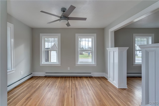 spare room featuring ceiling fan, a baseboard radiator, and light wood-type flooring