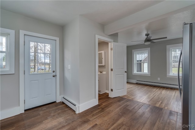 foyer featuring dark hardwood / wood-style flooring, plenty of natural light, and a baseboard heating unit