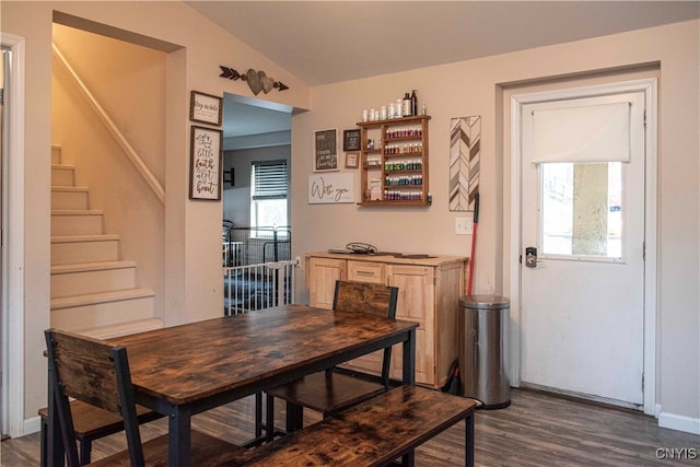 dining space featuring dark hardwood / wood-style flooring and lofted ceiling