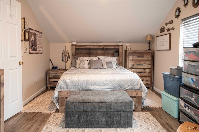 bedroom featuring wood-type flooring and vaulted ceiling