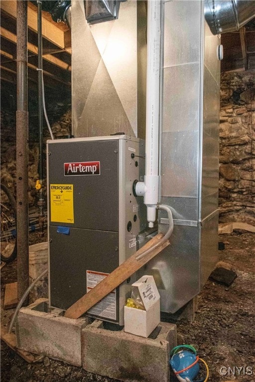 utility room featuring heating unit