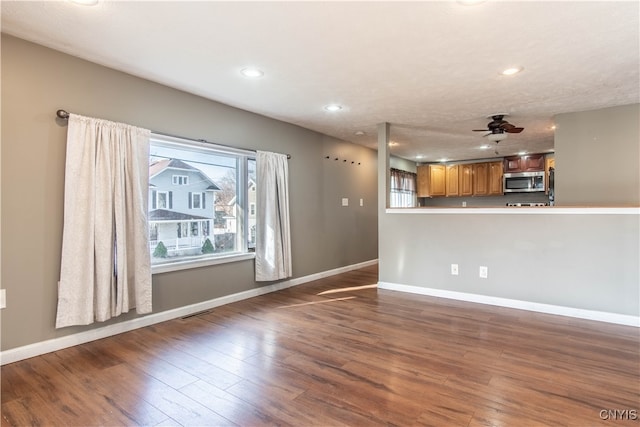 unfurnished living room with hardwood / wood-style flooring and ceiling fan